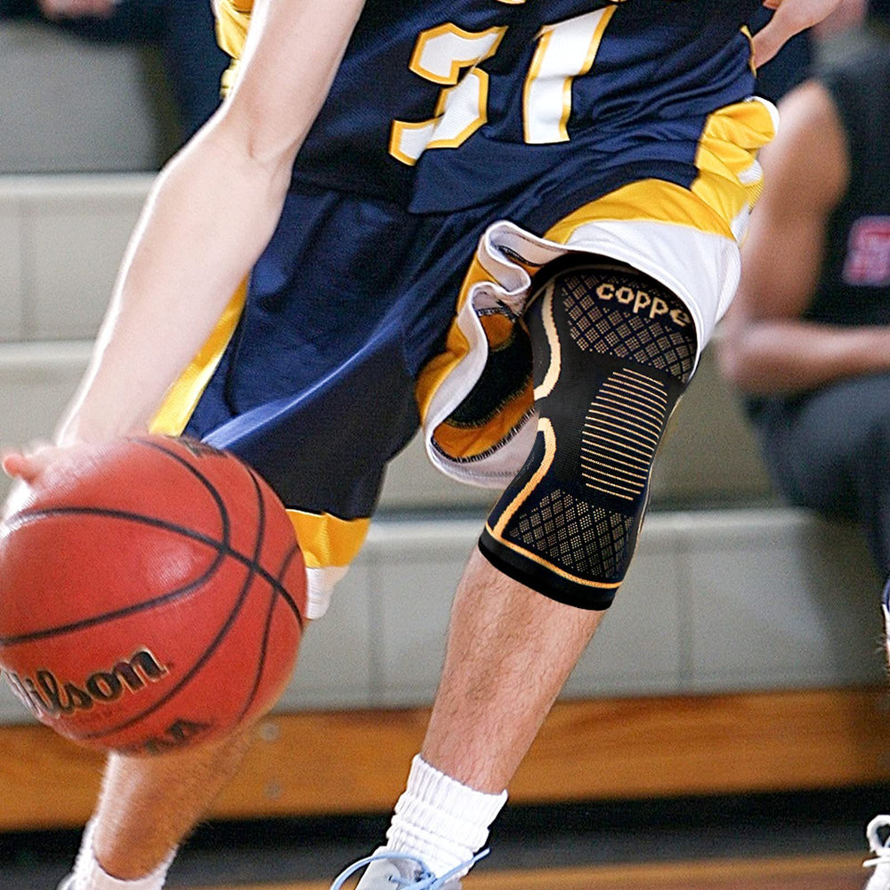 Copper knee compression sleeve worn by a basketball player during a game