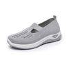 Grey knit mesh slip-on walking flat with white cushioned platform sole, three-quarter studio view