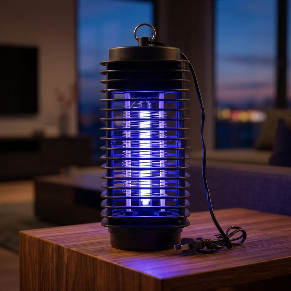 UV light on - plug-in bug zapper glowing indoors at night