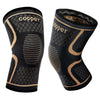Copper knee compression sleeves pair, black and gold knit, front and inner cuff view on white background