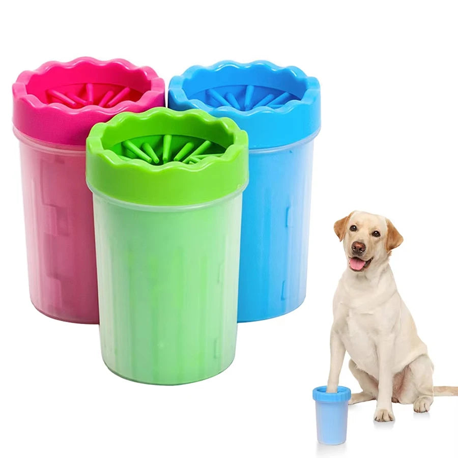 Dog paw cleaner cup with soft silicone bristles in pink, green and blue with a dog