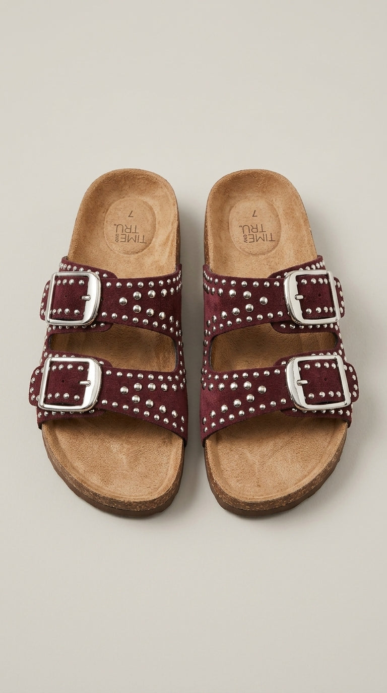 Studded two-buckle slide sandals worn with jeans
