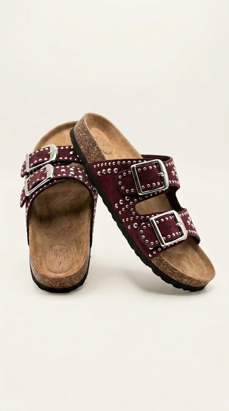 Studded sandals styled on a green couch