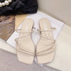 Beige strappy flat slide sandals - pair, top view