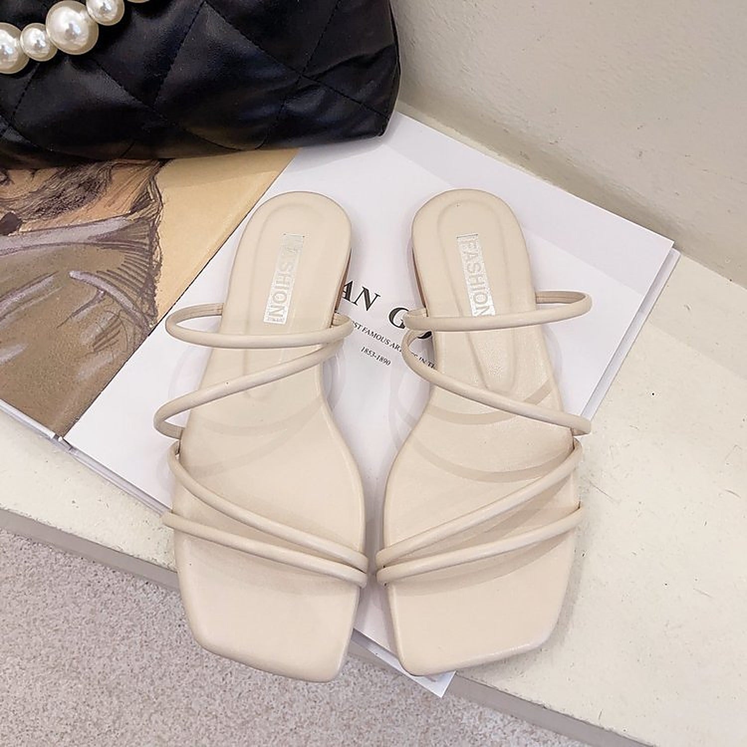 Beige strappy flat slide sandals - pair, top view