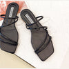 Black strappy flat slide sandals - pair, top view