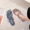 Blue strappy flat slide sandals worn