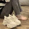 Beige chunky platform sneakers styled photo