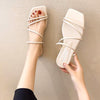 Beige strappy flat slide sandals worn