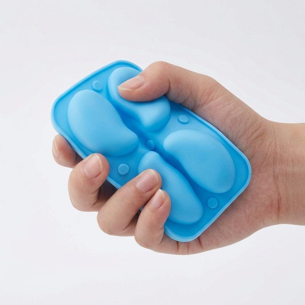 Hand squeezing the flexible silicone mold to show easy release