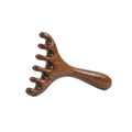 Sandalwood five-prong scalp massager comb on white background